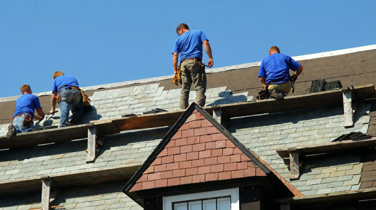 Roof replacement in progress with a team of professional contractors installing new shingles on a residential home in Gilbert, AZ